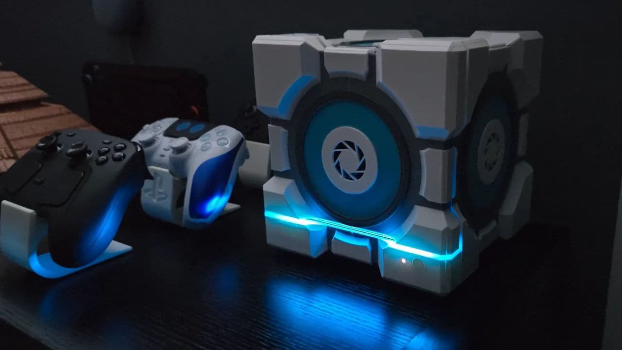A 3D printed Steam Machine Companion Cube case in black and white panels with a Portal Companion Cube design