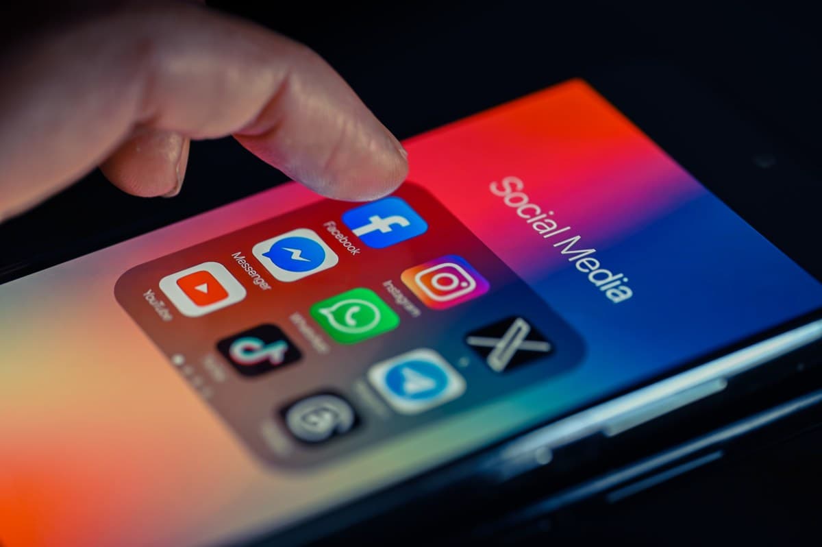 Court gavel and smartphone with social media app icons representing legal battles over platform addiction