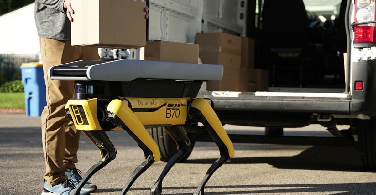 Boston Dynamics Spot robot with conveyor belt accessory unloading a package at a doorstep