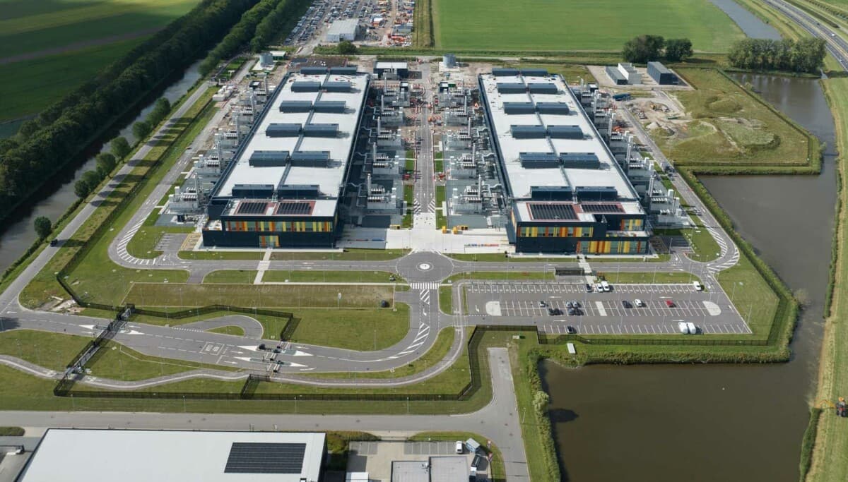 Aerial view of large data center facility in rural Ireland with power lines in foreground