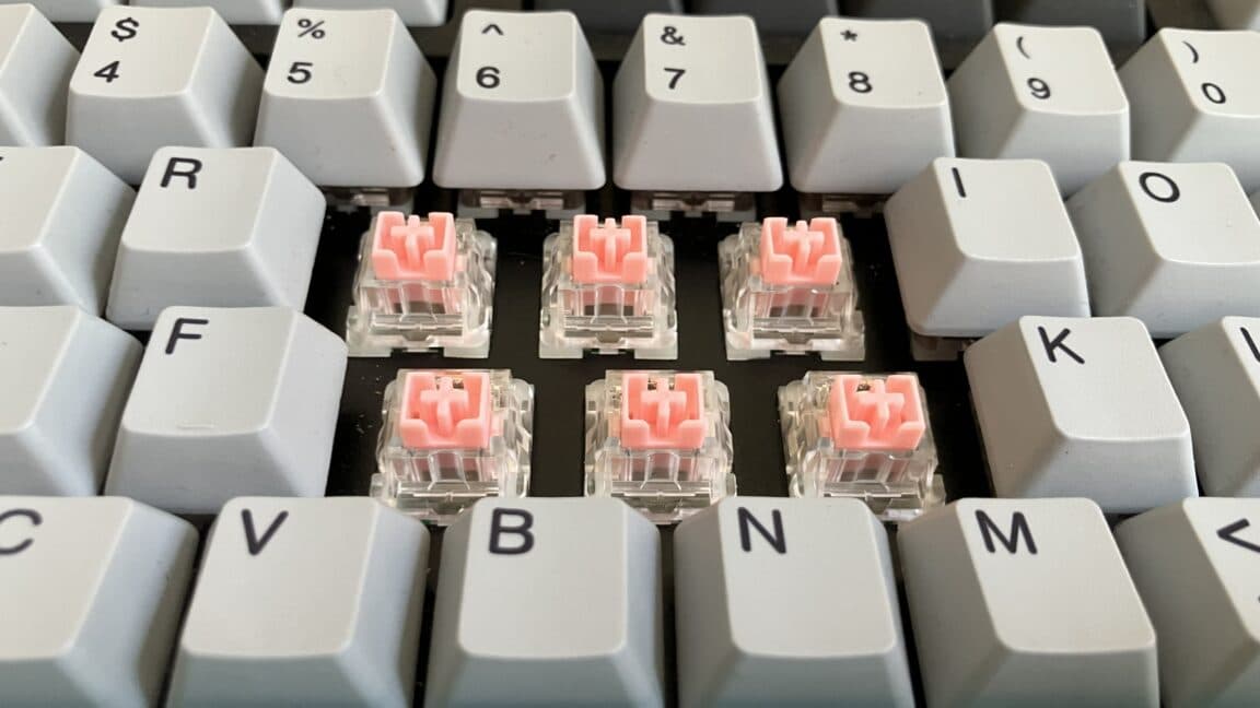 Close-up of a mechanical keyboard with Hall-effect and TMR switches showing magnetic sensor components