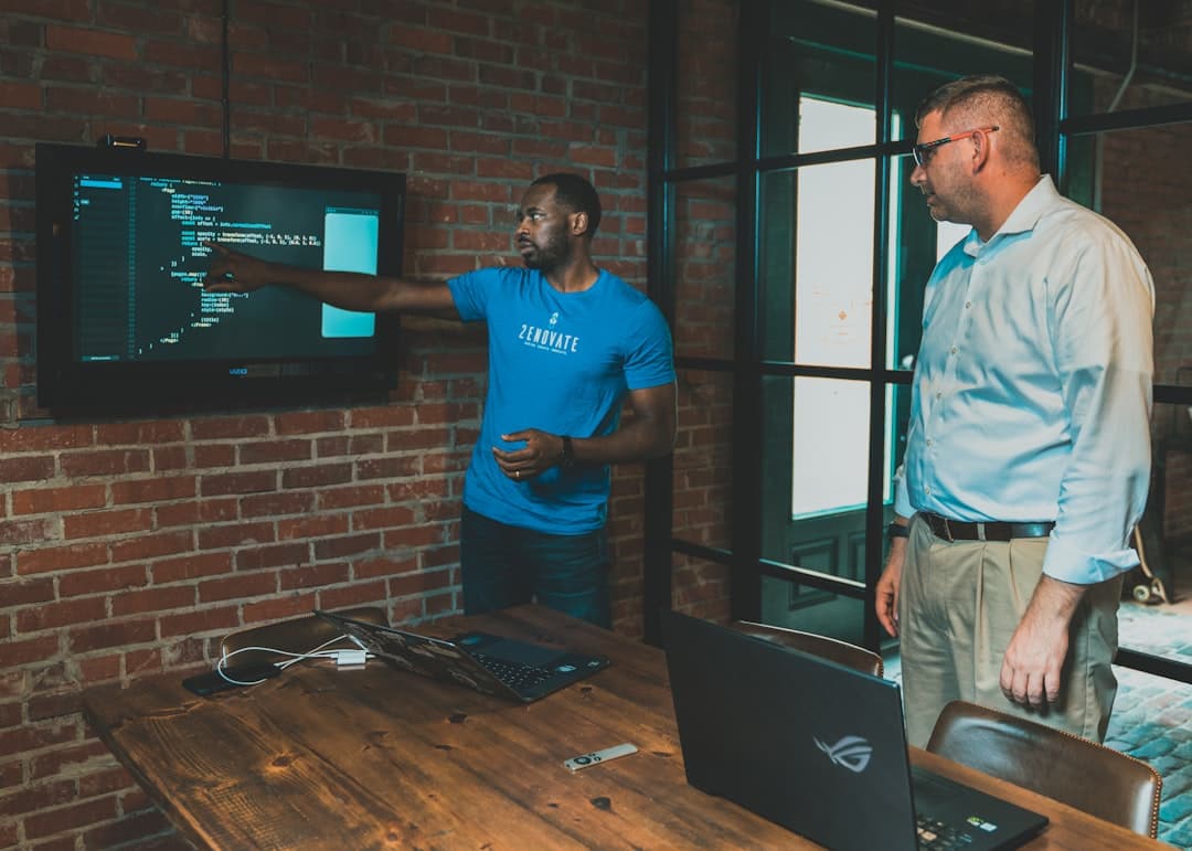 A software engineer sketching architecture diagrams on a whiteboard with notes about memory and data volume