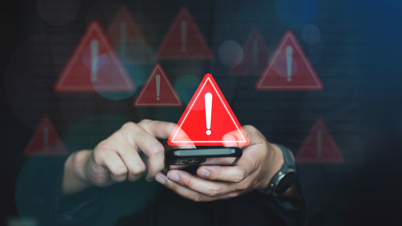 Android phone displaying a spyware warning alert with security icons in background