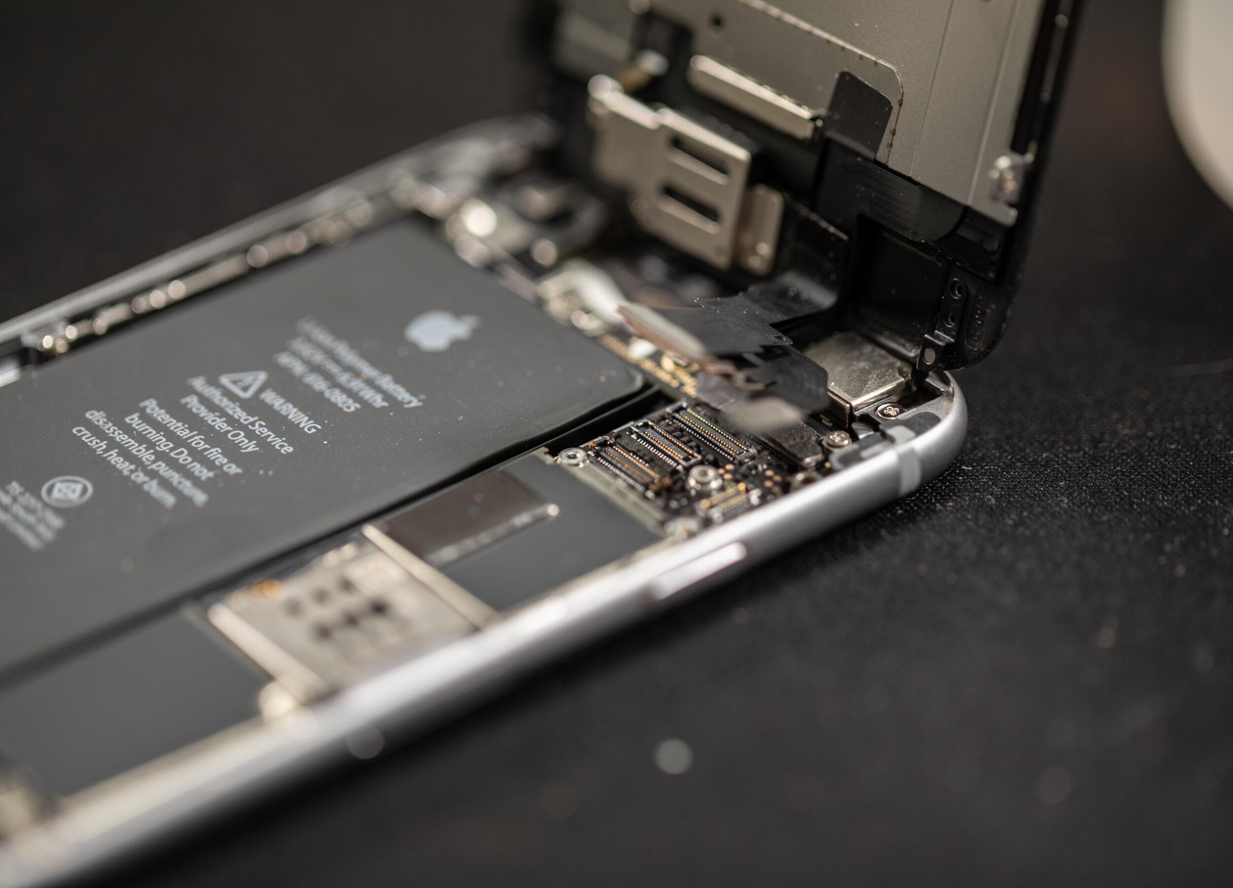 A technician replacing the battery inside an Apple iPhone 18 Pro smartphone