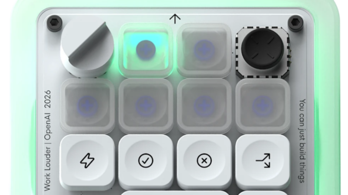 Top view of the OpenAI Codex Micro mini-keyboard with six frosted keys glowing in blue and green against a wooden desk