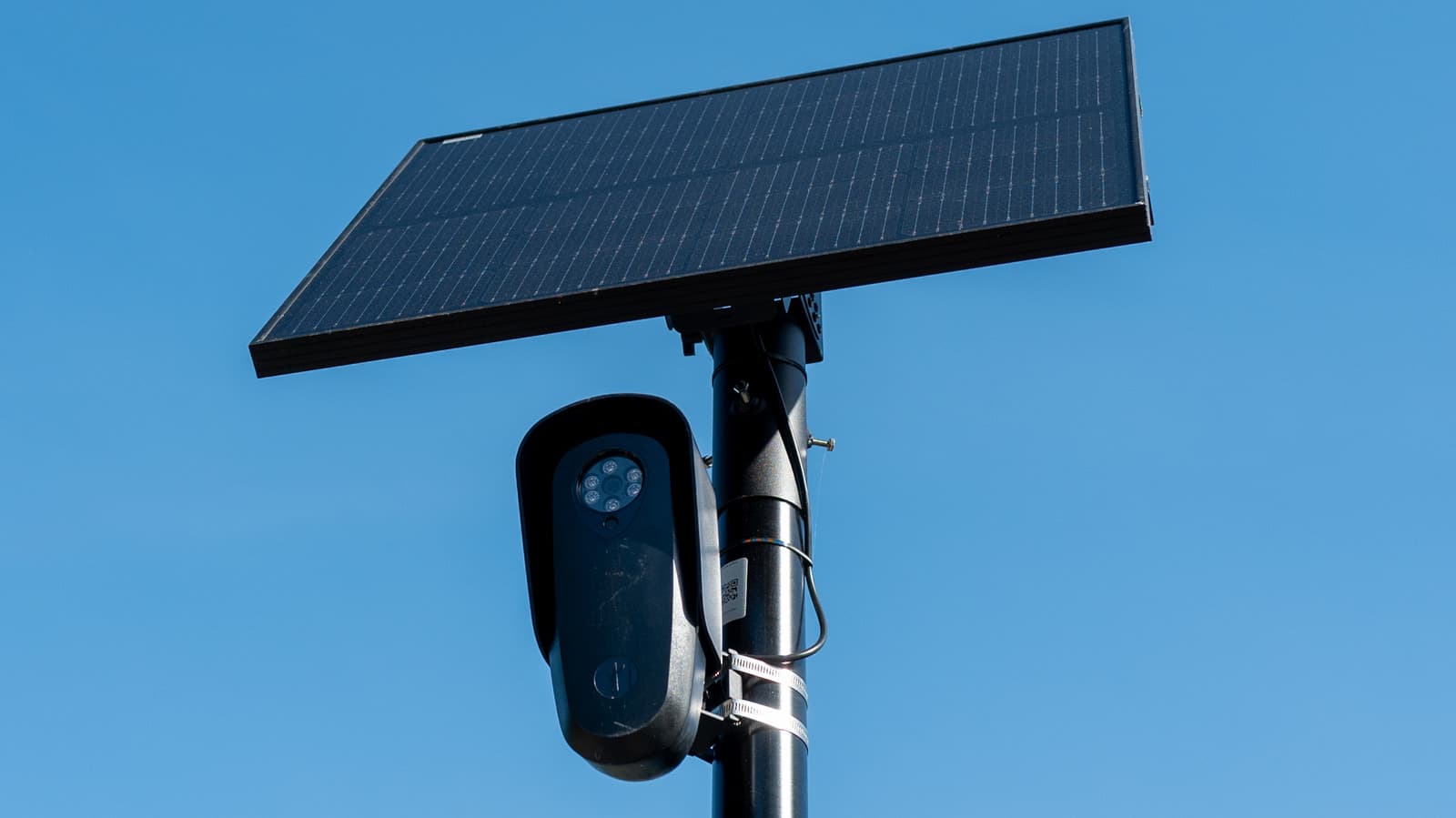 Flock Safety license plate recognition camera mounted on a pole in a residential neighborhood