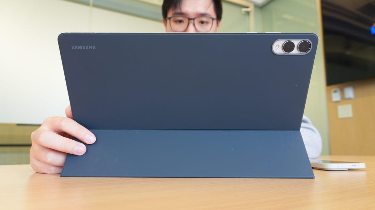 A selection of large tablets from Apple, Samsung and Microsoft on a desk, showcasing their big screens and accessories