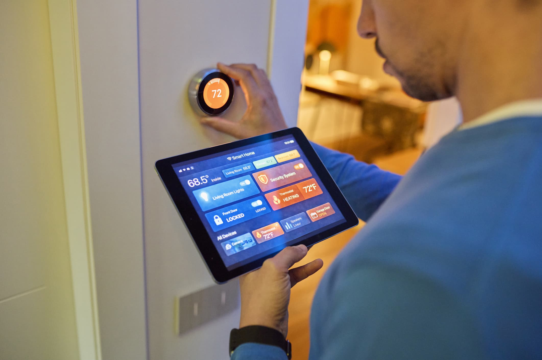 Smart thermostat on a wall displaying temperature and humidity readings in a modern home