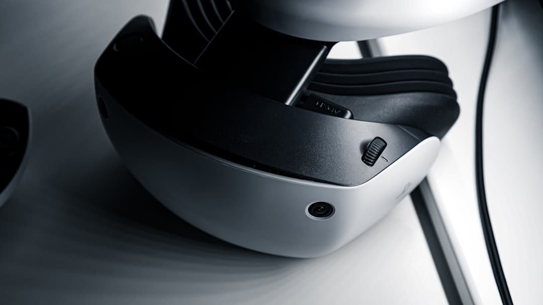 PlayStation controller next to stacked game cases and a digital download icon