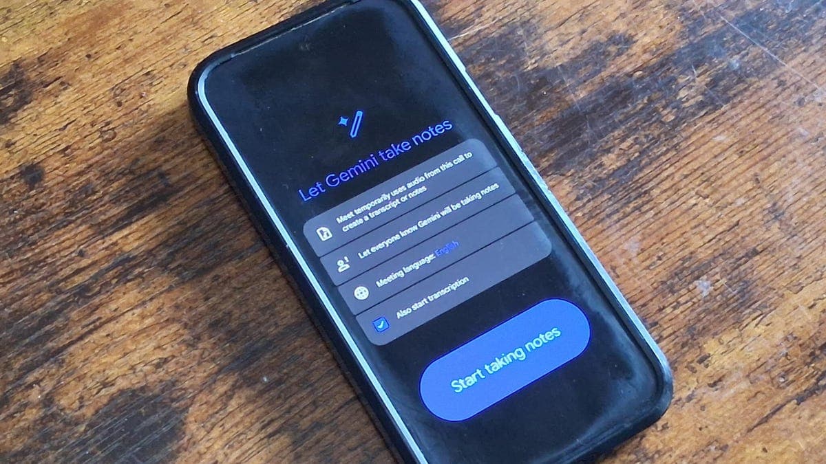 Person using smartphone with Google Meet app to record an in-person meeting transcript