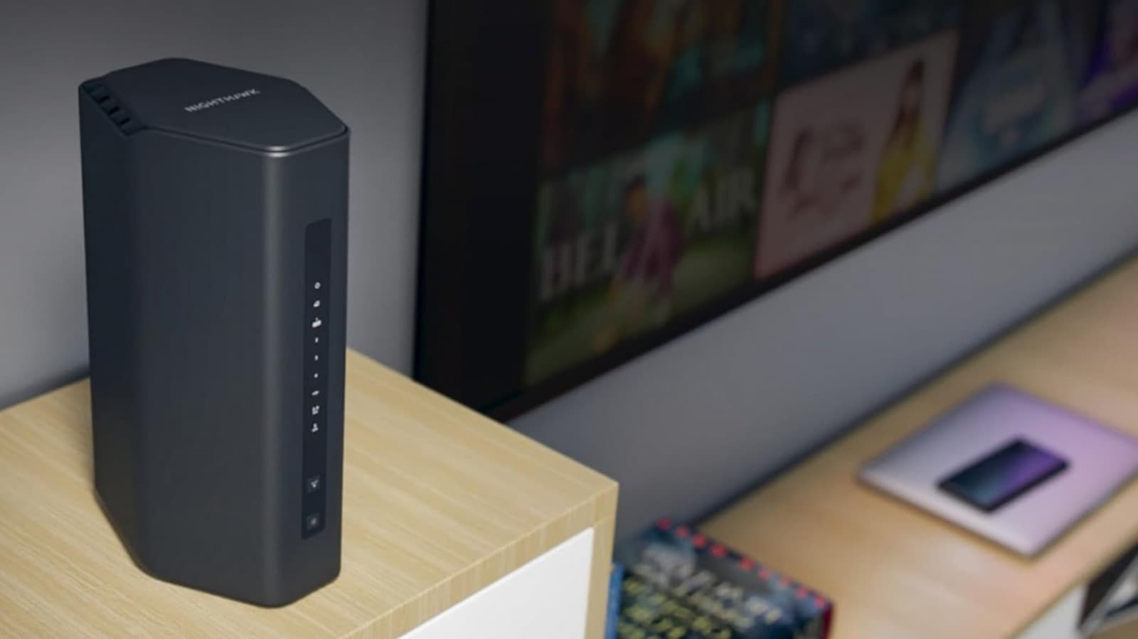 Netgear Nighthawk router with multiple antennas on a desk in a home office setting