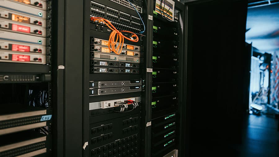 A server rack in a modern data center with blinking lights, representing on-premise infrastructure.