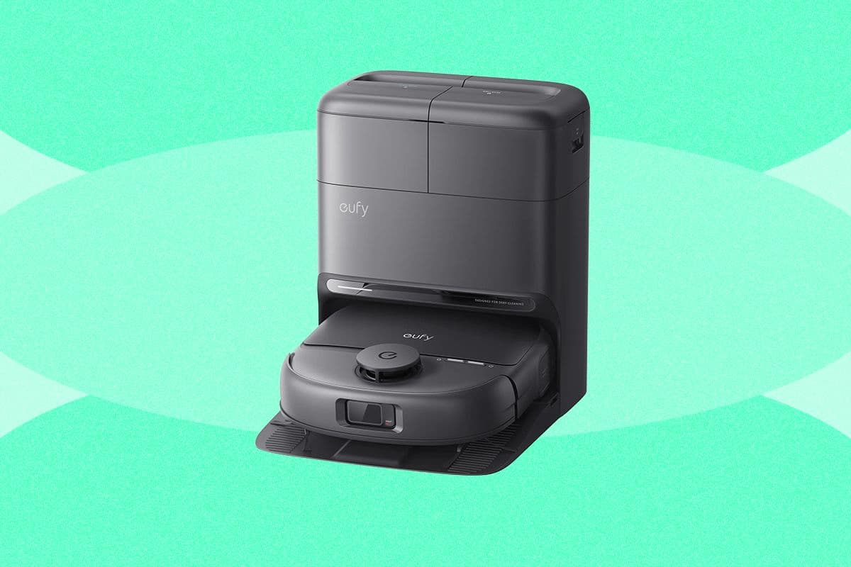 A modern robot vacuum cleaner navigating around furniture in a living room