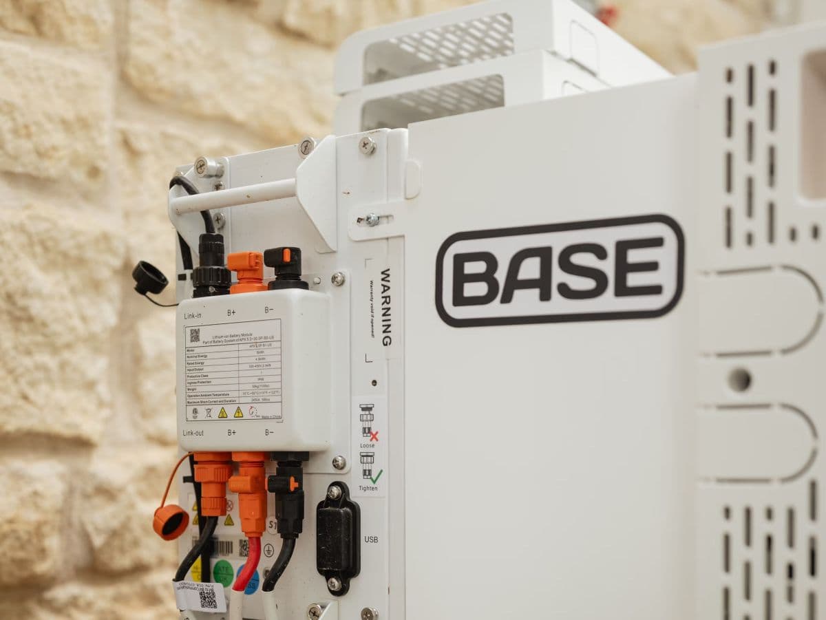 Residential battery unit installed in a backyard for grid storage and home backup