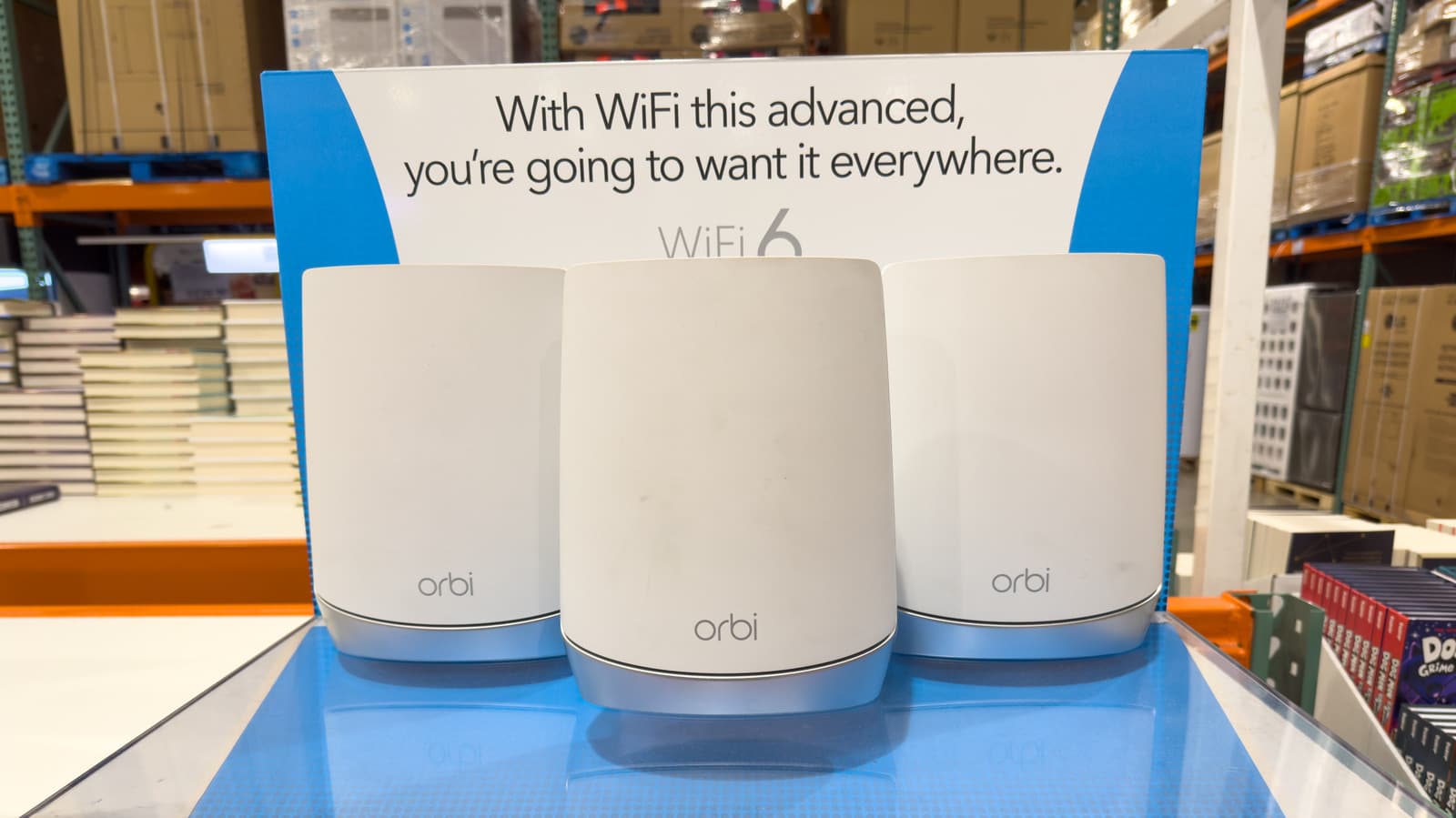 Netgear Orbi 970 mesh router and satellite on a modern desk