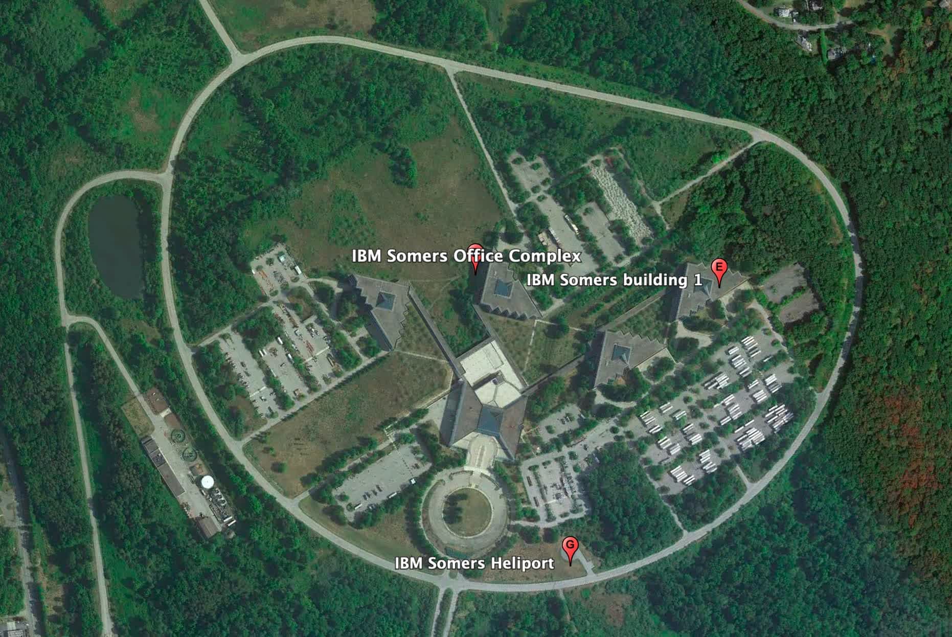 Abandoned IBM office buildings with pyramid structures surrounded by overgrown grass