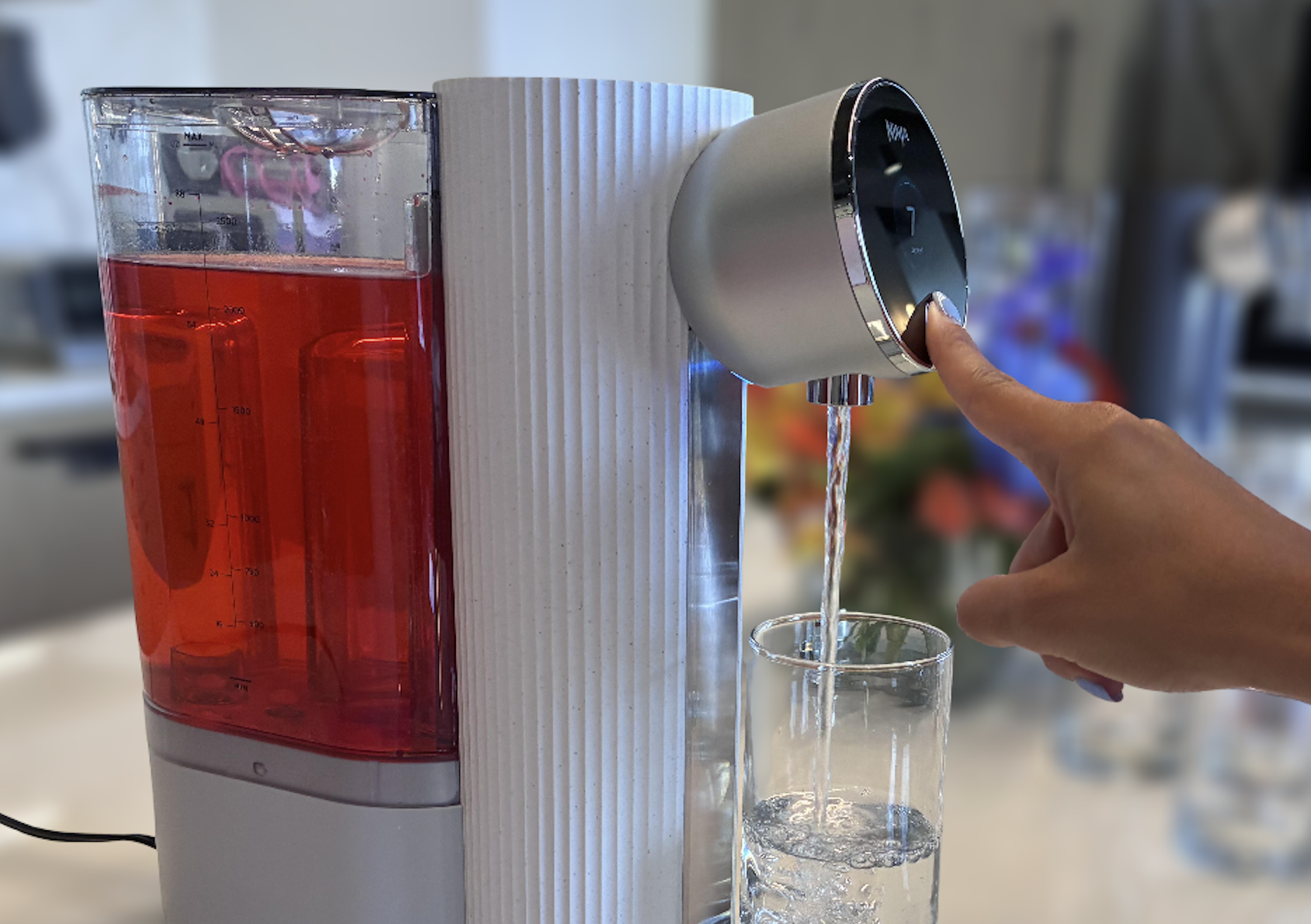 Ninja countertop water filter pitcher next to a glass of clear water on a kitchen counter