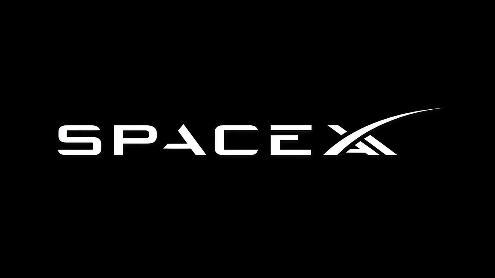 SpaceXAI logo on a digital display with SpaceX branding and rocket imagery