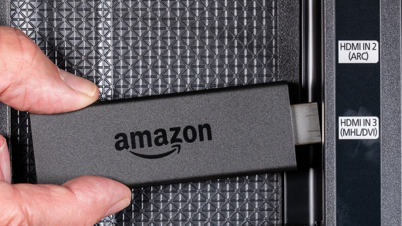 Amazon Fire TV Stick remote and streaming device on a table