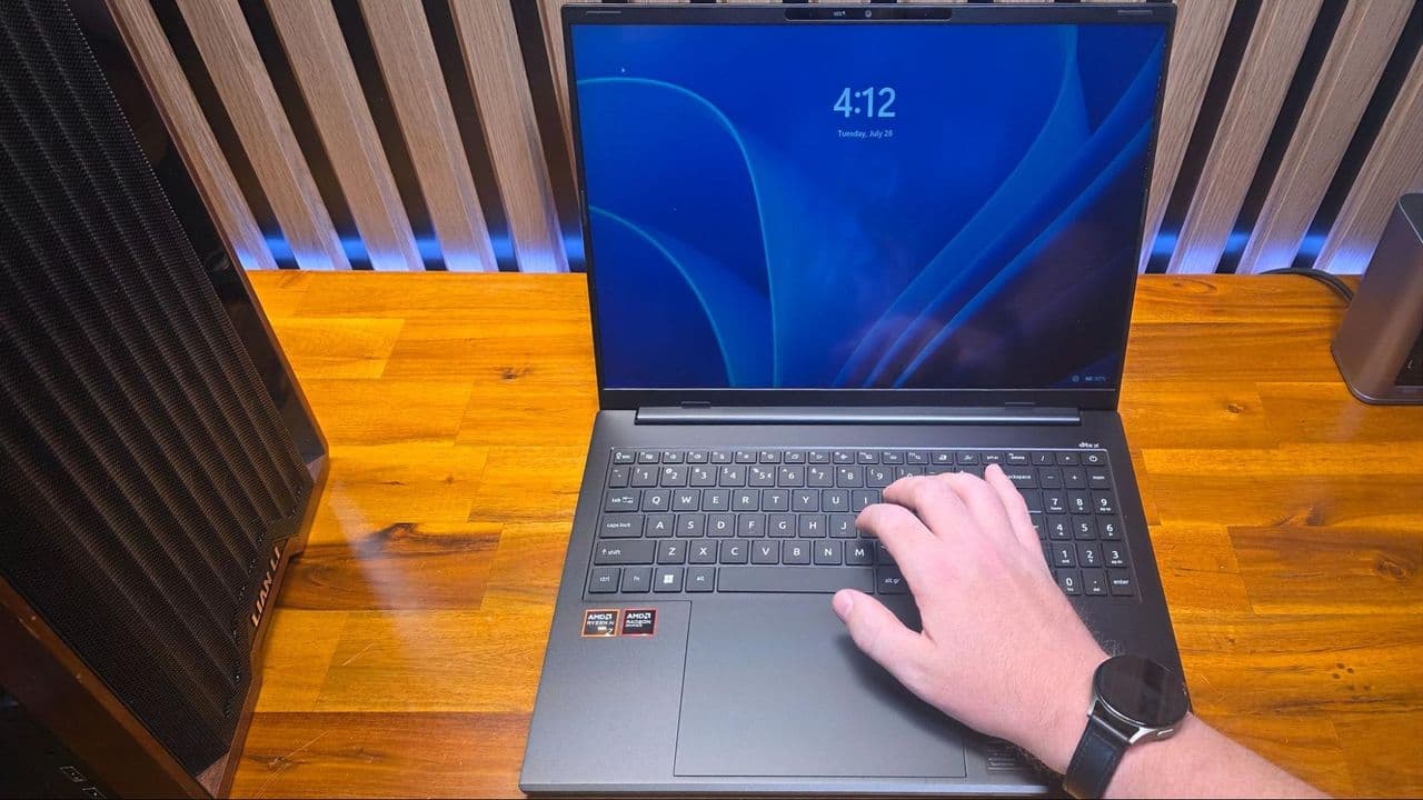 A laptop keyboard with a magnetic clasp watch band near the palm rest, illustrating how the magnet triggers the lid sensor