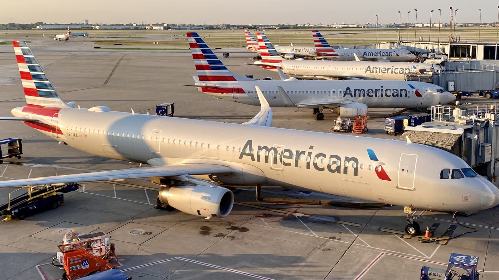Passengers evacuating an American Airlines aircraft after a laptop fire on the runway