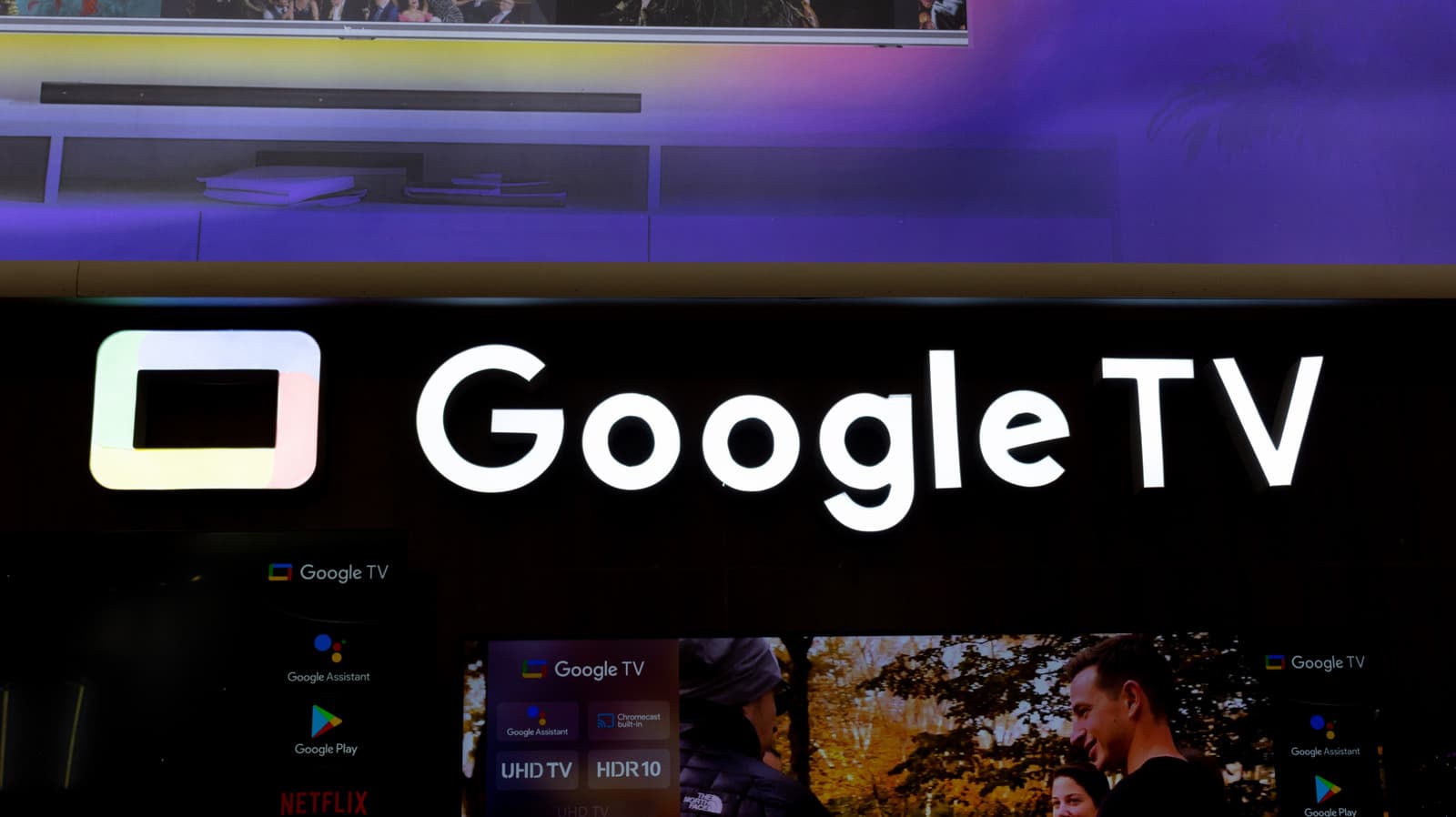 Google TV interface on a television screen with remote control on a table