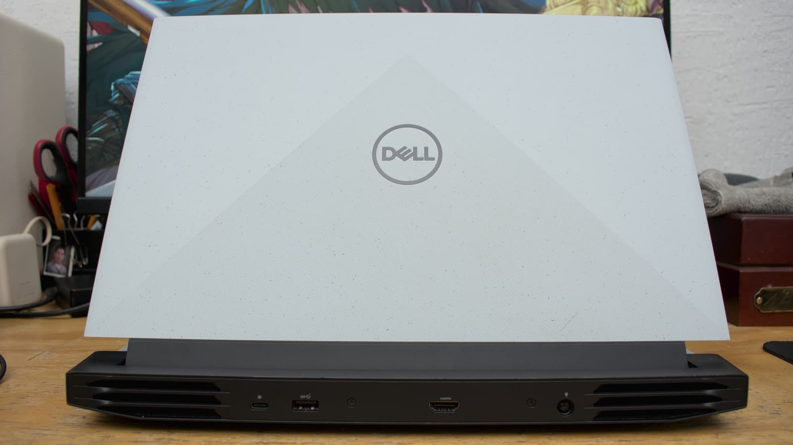 Dell laptop with visible wear on hinge and keyboard area
