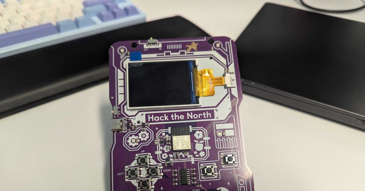 Rows of programmable printed circuit board badges laid out for assembly before a large hackathon