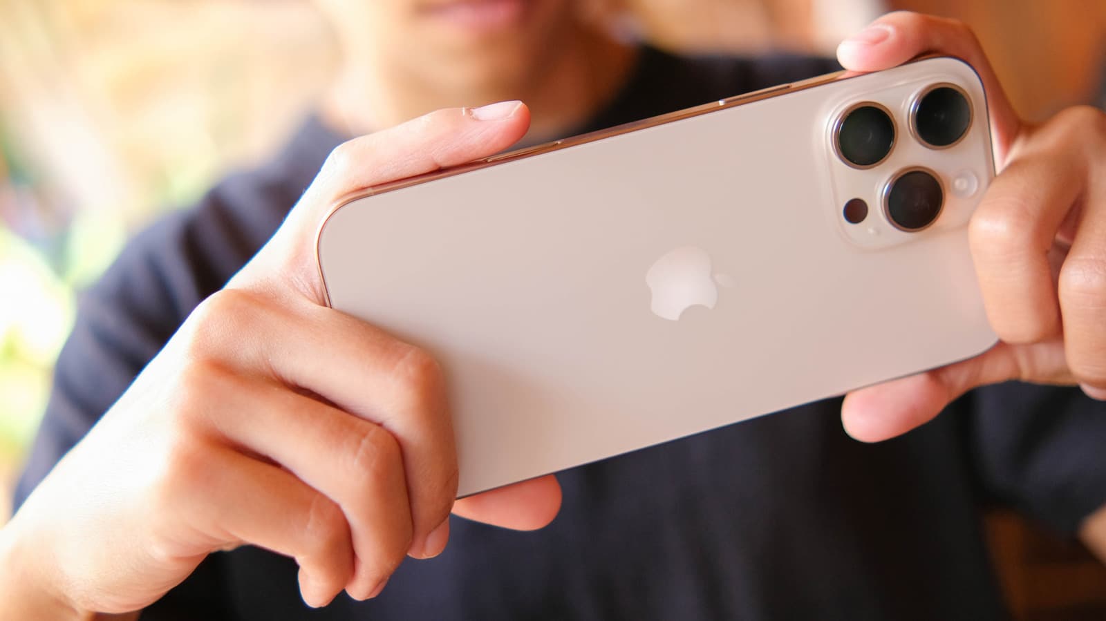 Close-up of an iPhone screen showing a yellow battery icon in the status bar indicating Low Power Mode