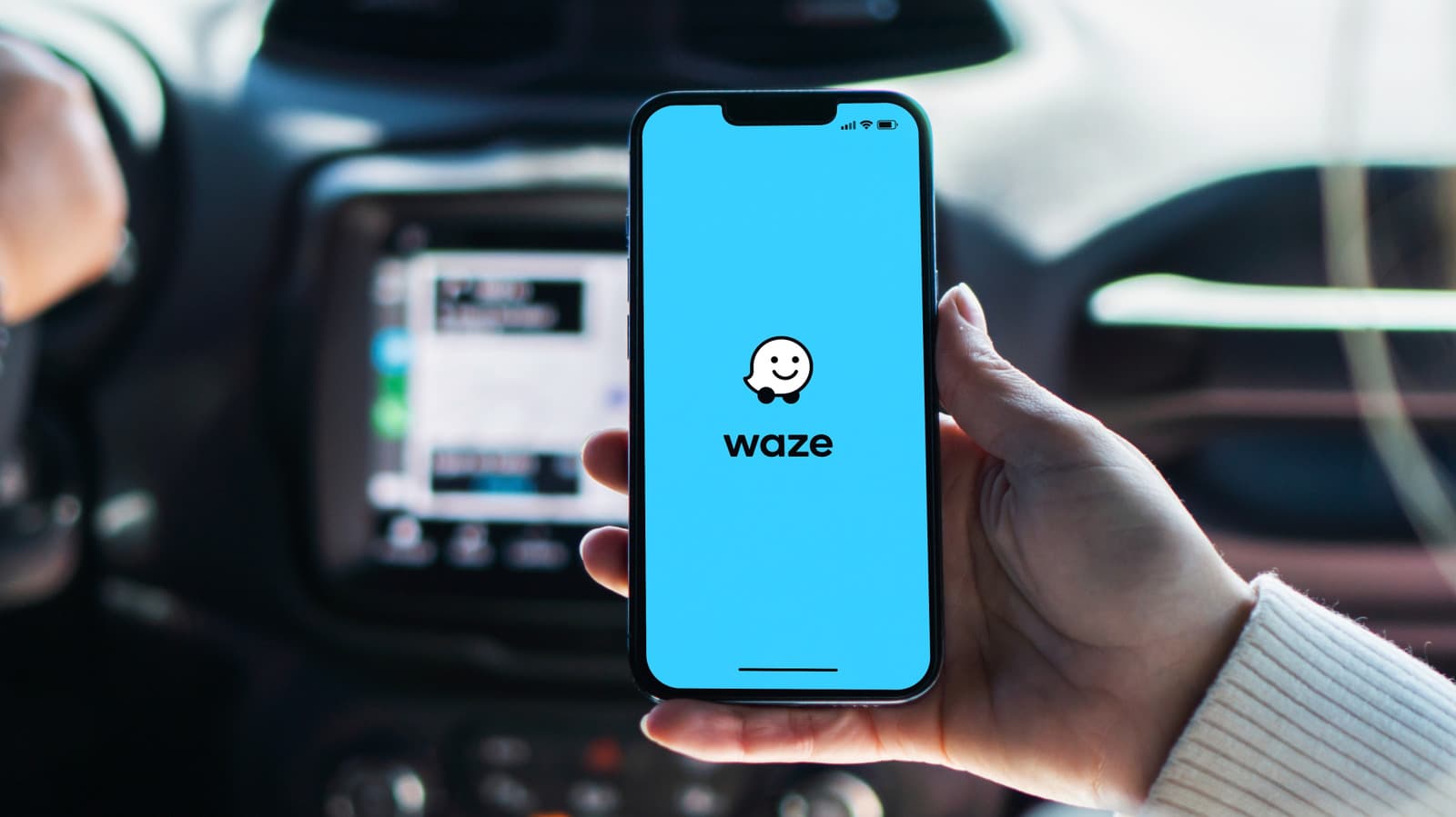 Waze navigation app on smartphone screen showing route with traffic alerts