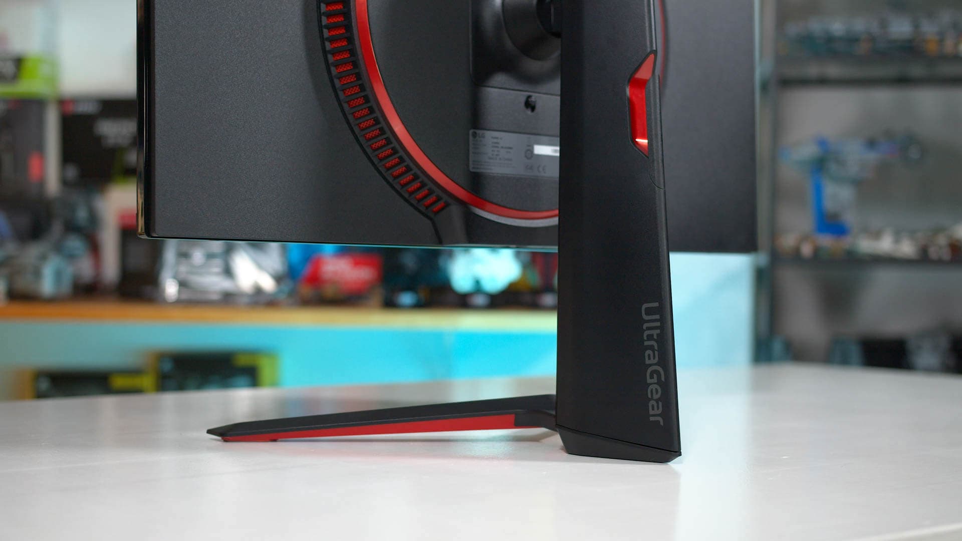 LG and Alienware monitors displayed on a desk with McAfee adware popup on a Windows PC screen illustrating unwanted software