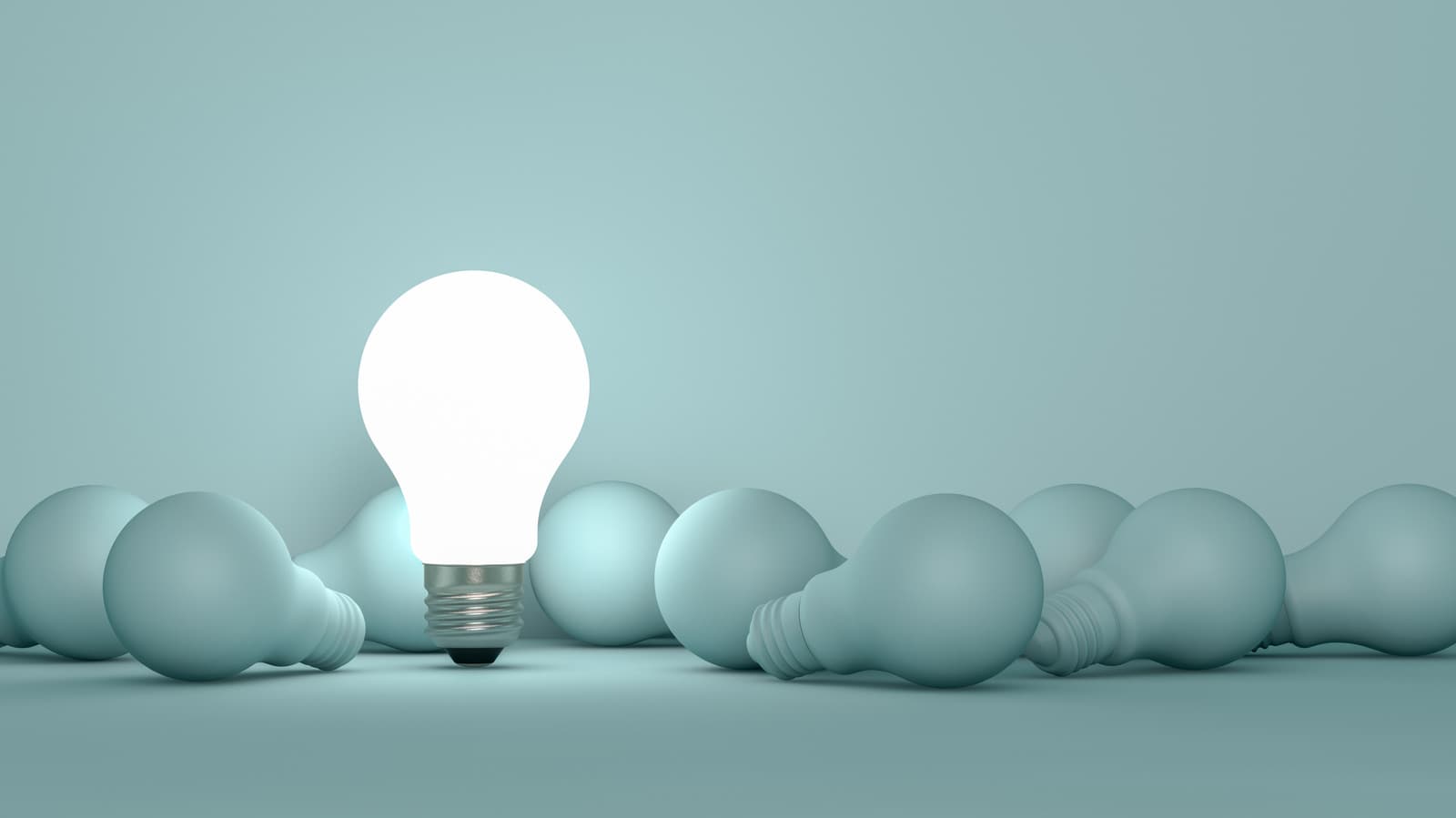 Smart bulb glowing near a smartphone app on a wooden table