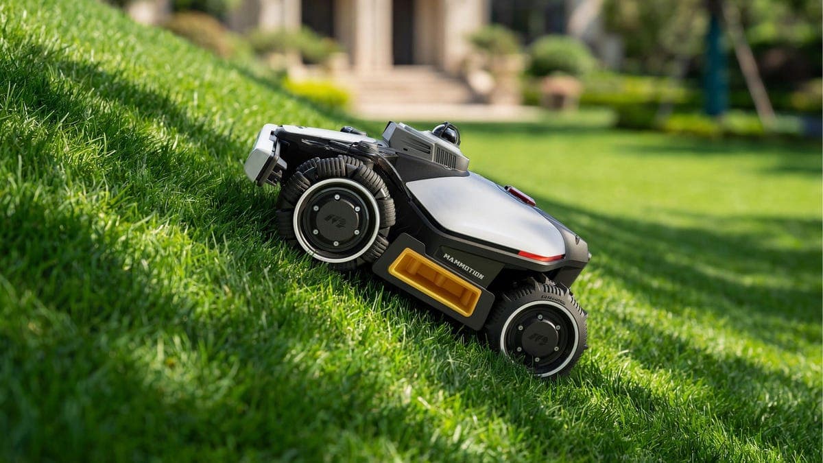 Mammotion LUBA robot mower on a sloped lawn demonstrating hill-climbing capability