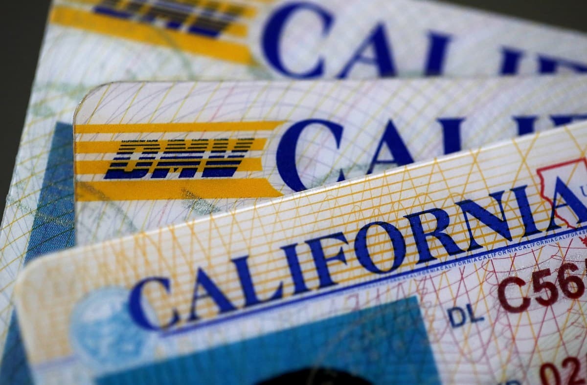 Close-up of a driver's license card with a digital lock icon overlay symbolizing data security breach