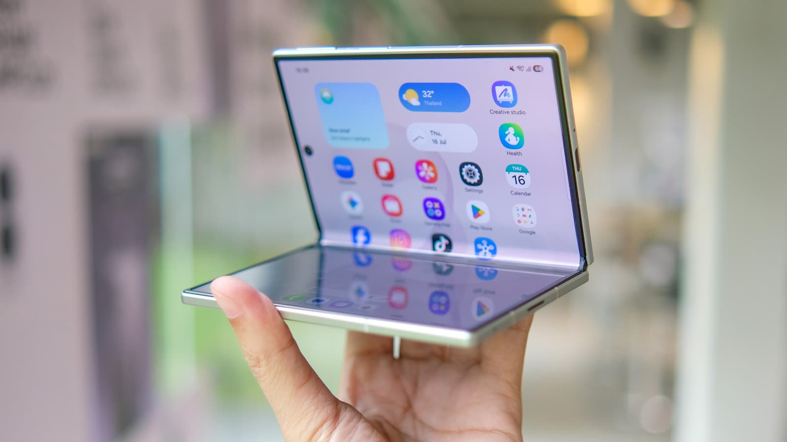 Foldable phone displaying a split-screen app with two panels showing content and controls