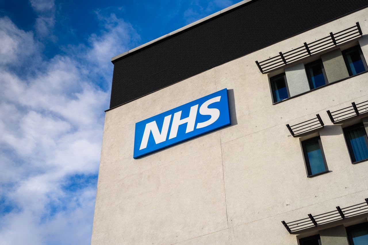 Healthcare professionals using computers in an NHS hospital office setting