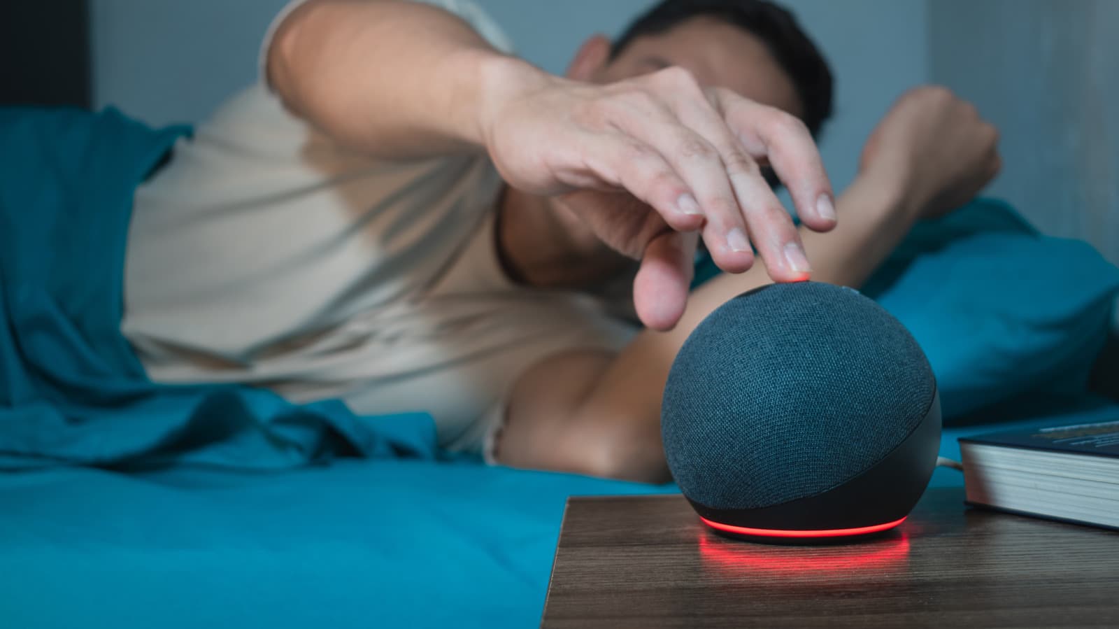 Amazon Echo smart speaker displaying a red light ring on its base indicating microphone mute status
