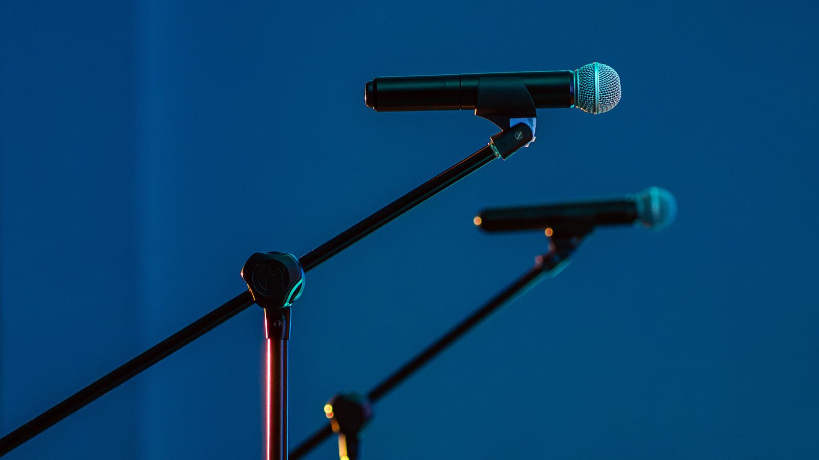 Two microphones positioned at different distances from a sound source on a studio desk