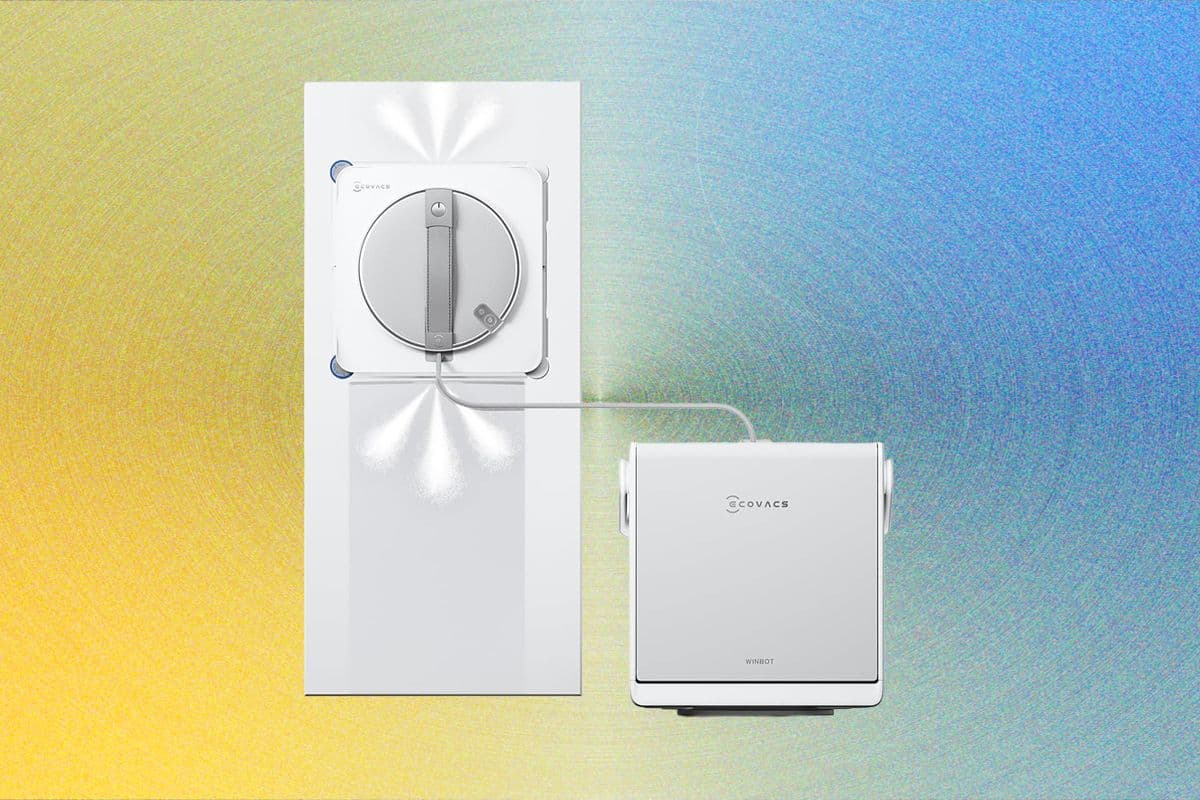 Ecovacs Winbot W2S Omni robotic window cleaner on a sash window with wooden frame