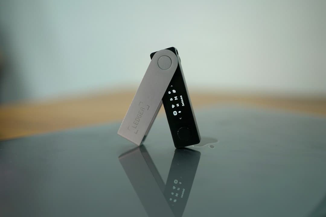 A hardware cryptocurrency wallet device with a magnifying glass revealing a hidden microchip on its circuit board