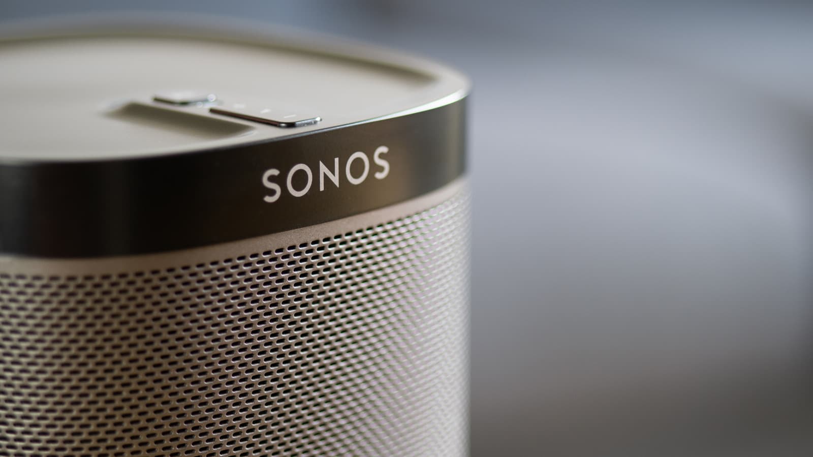Sonos speaker being set up with a smartphone showing the Sonos app