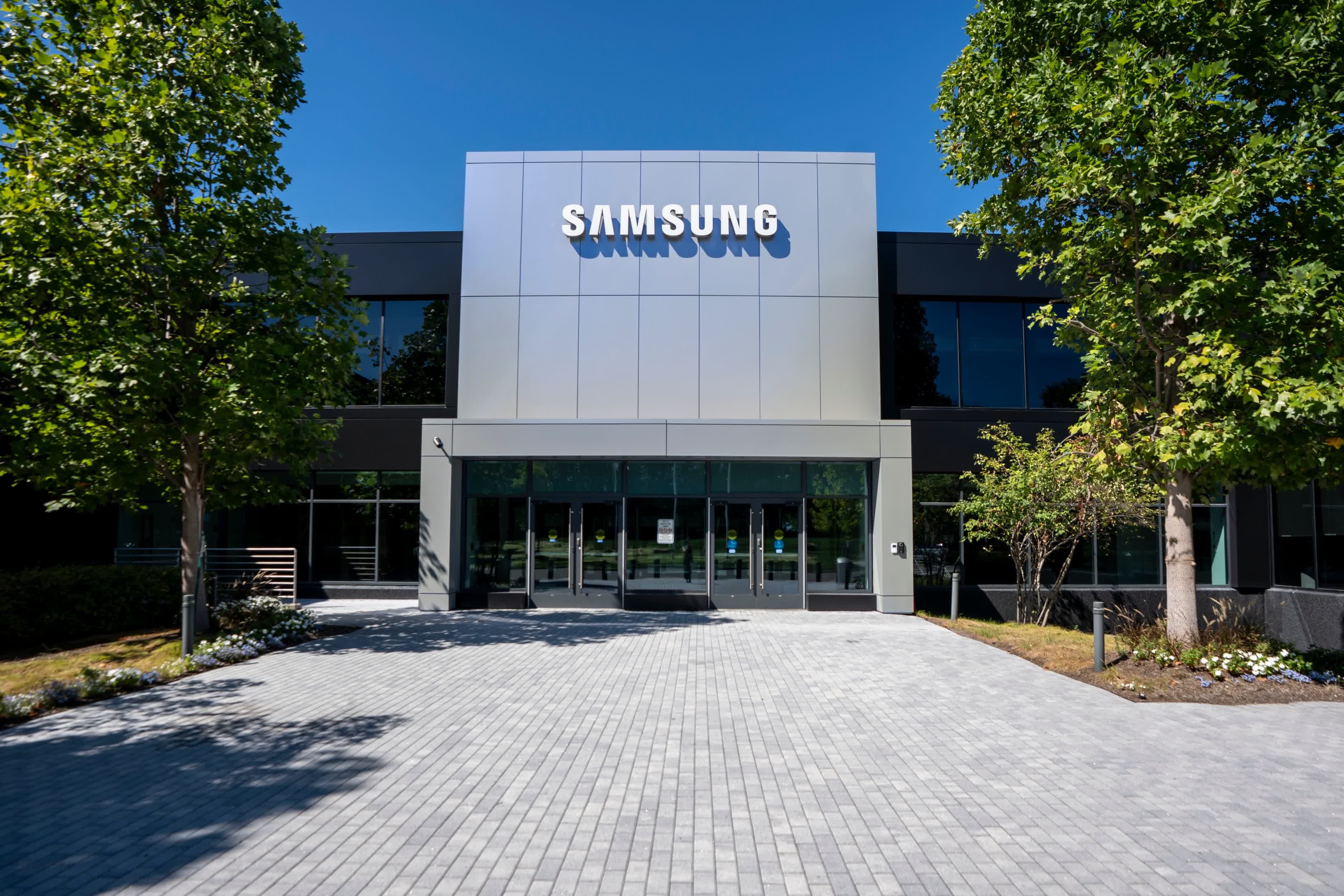 Samsung Electronics America building exterior with company logo reflected in glass, symbolizing corporate restructuring.