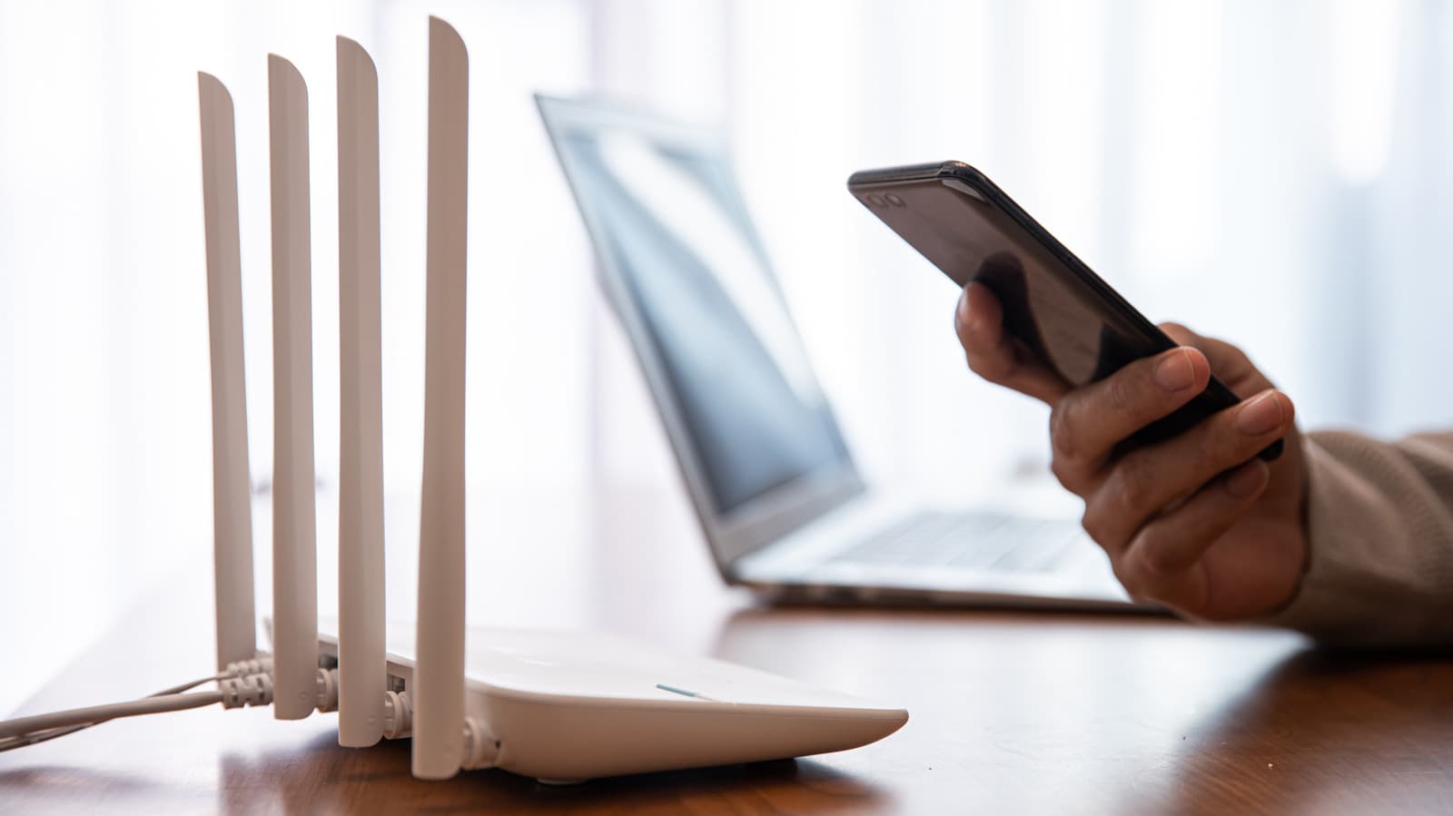 Wi-Fi router with glowing lights symbolizing a guest network feature for security