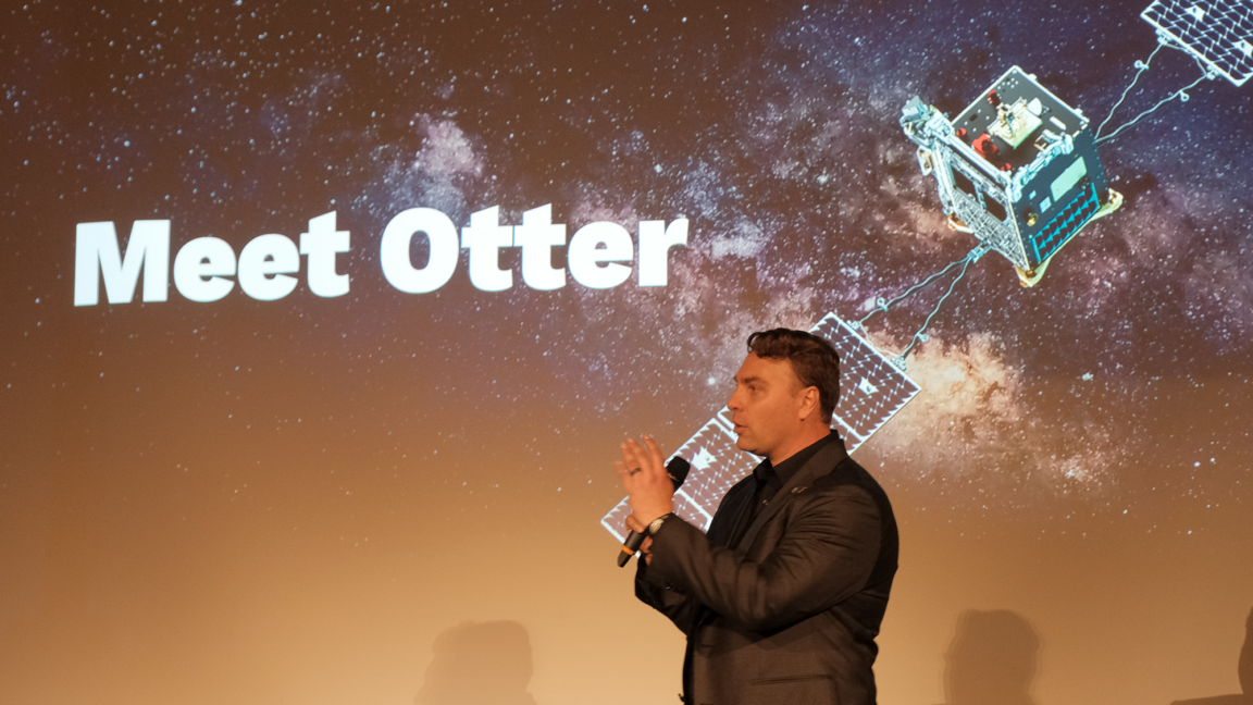 Artist concept of the Otter spacecraft docking with a satellite in low-Earth orbit